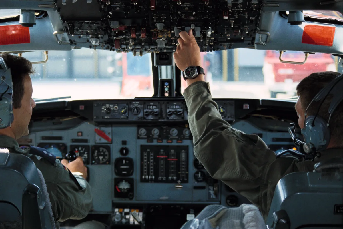 Pilot in AWACS cockpit with NATO chronograph