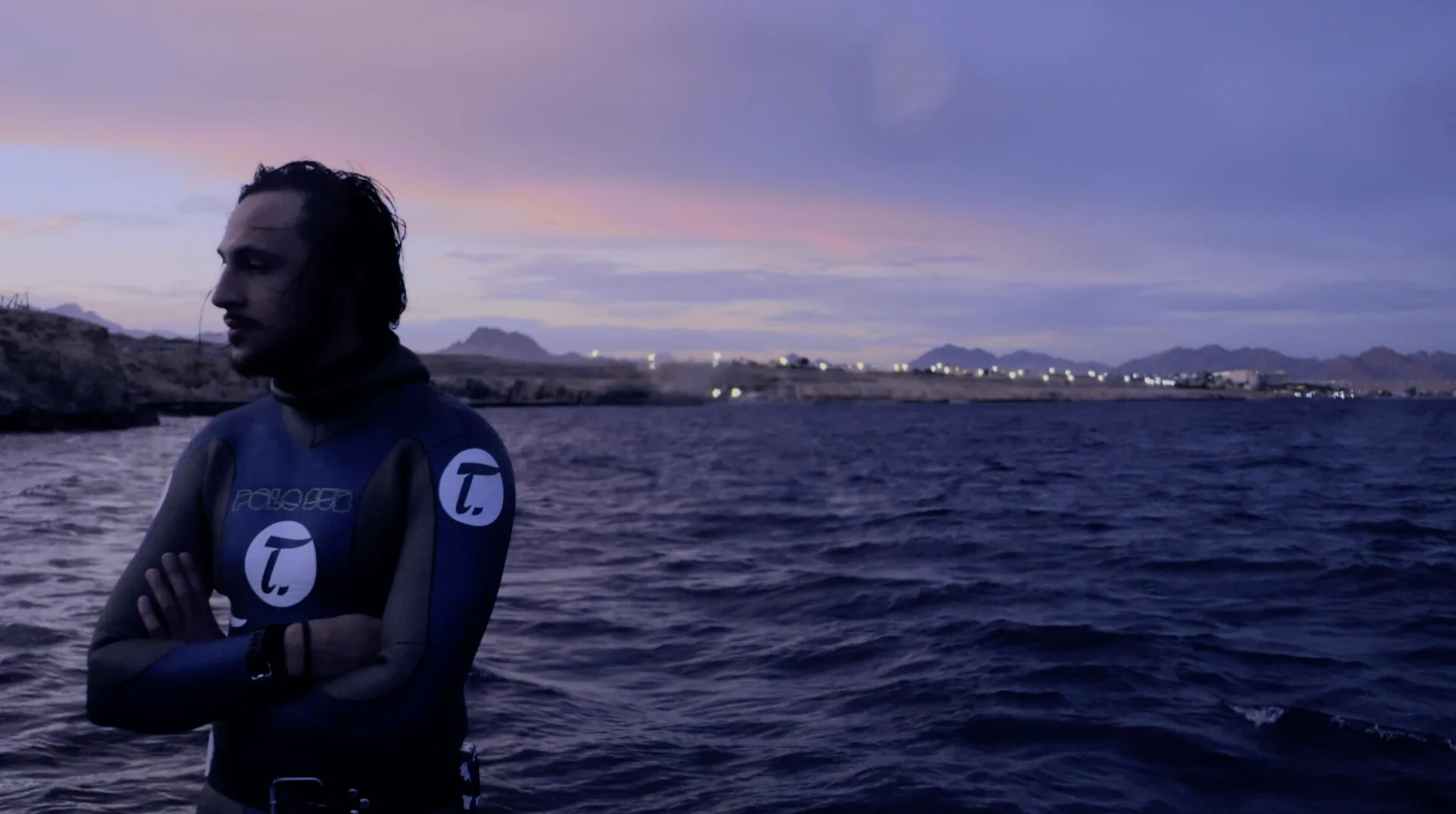 Freediver at dusk in Tutima wetsuit