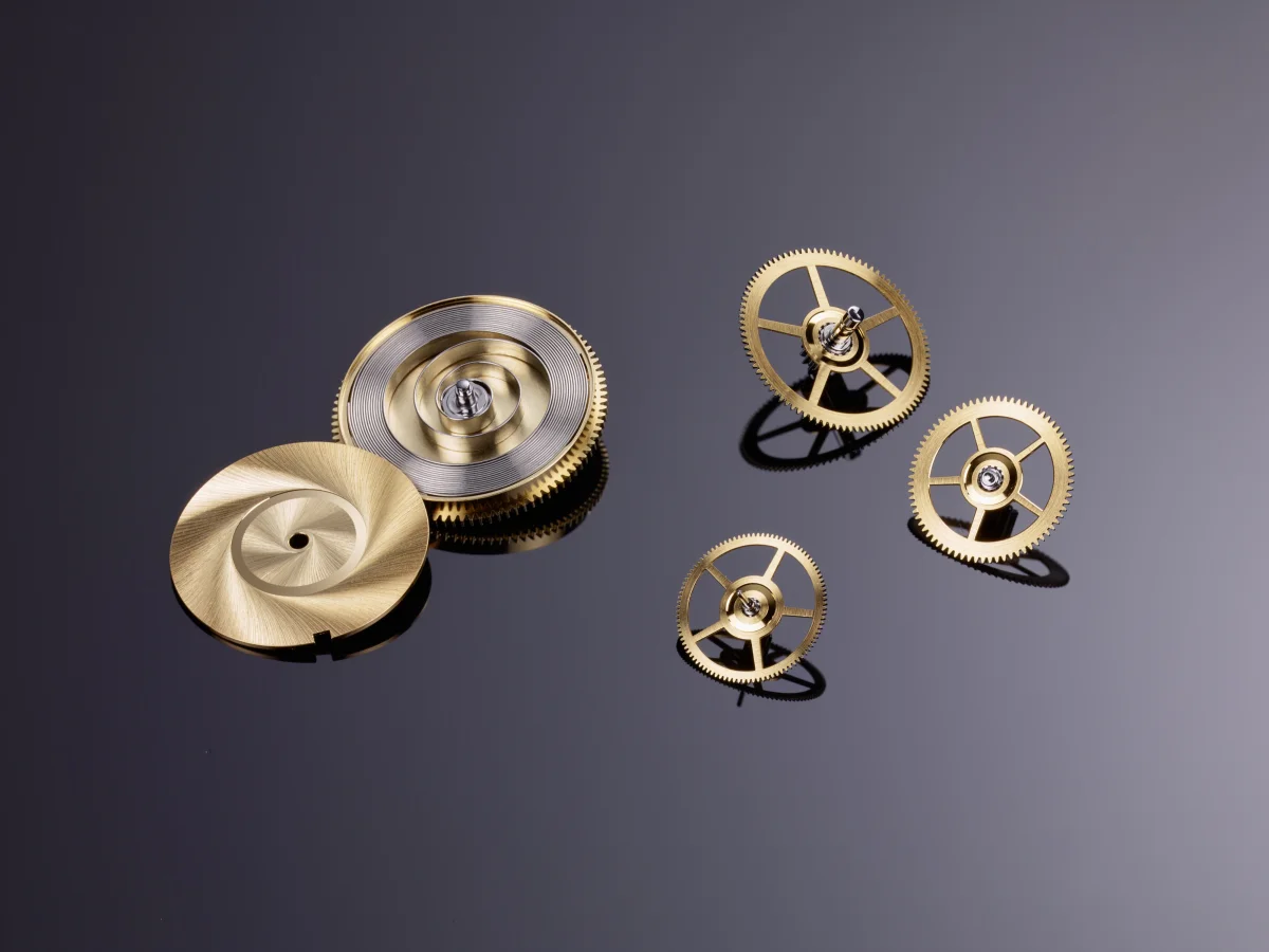 Caliber 617 mainspring barrel, crown wheel, and gear train components