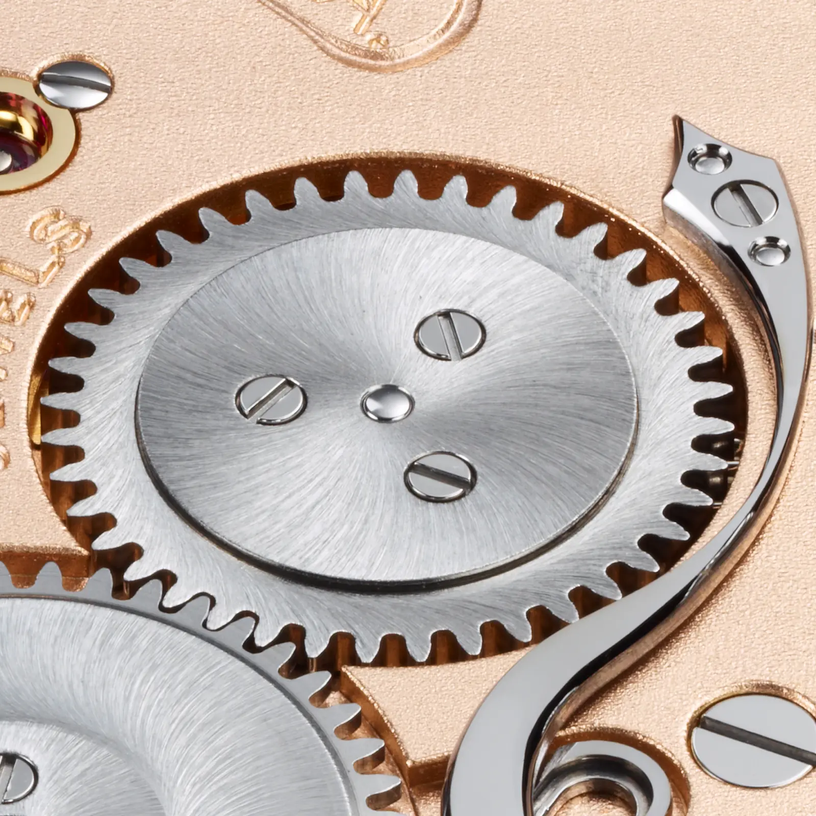 Caliber 800 — mainspring barrel, sun-brushed steel cap with polished click spring