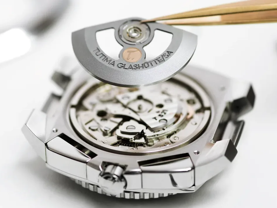 Tutima Glashütte rotor being placed into Saxon One chronograph — Caliber 521