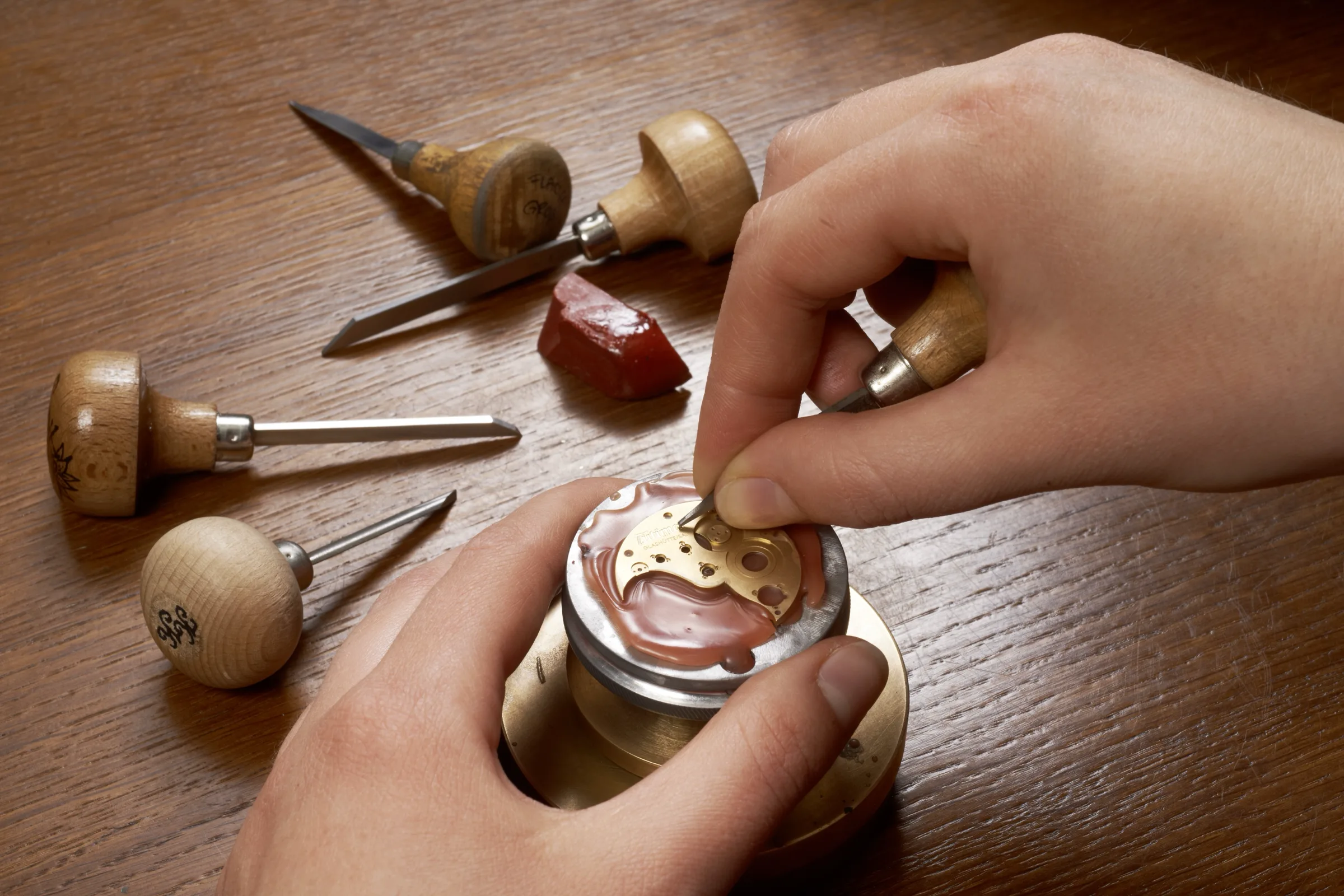 Hand-engraving a movement plate with traditional gravers at the Tutima Manufaktur