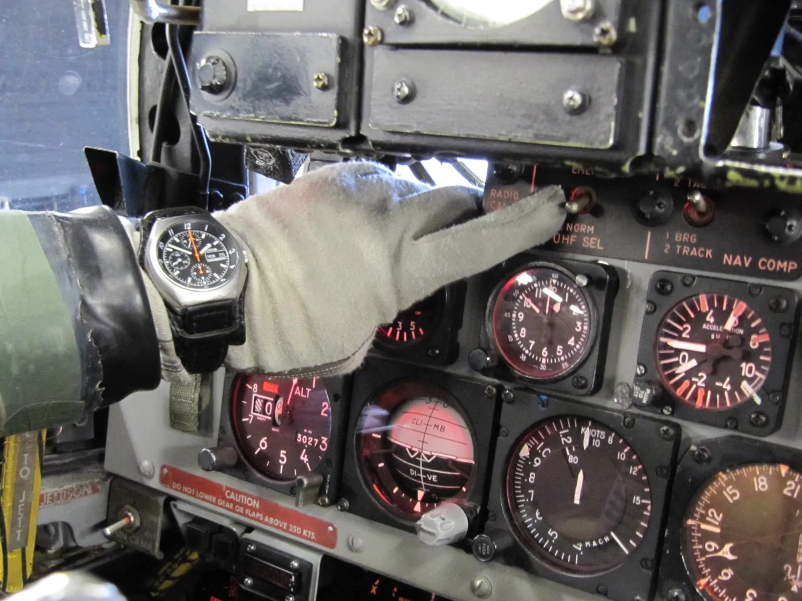 NATO chronograph on pilot's wrist against F-4 Phantom instrument panel