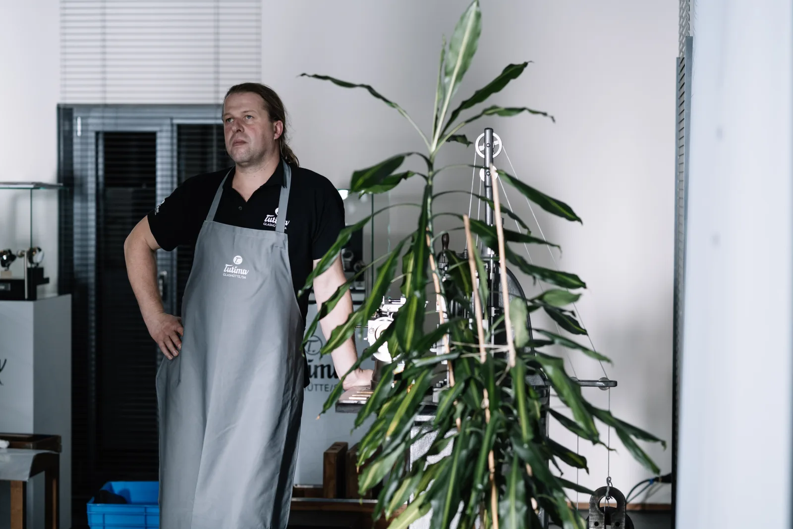 Watchmaker in Tutima-branded apron — still here, still working
